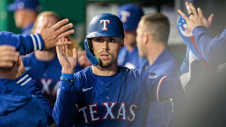 May 4, 2024; Kansas City, Missouri, USA; Texas Rangers outfielder Evan Carter (32) celebrates in the dugout after scoring during the seventh inning against the Kansas City Royals at Kauffman Stadium. May 4, 2024; Kansas City, Missouri, USA; Texas Rangers outfielder Evan Carter (32) celebrates in the dugout after scoring during the seventh inning against the Kansas City Royals at Kauffman Stadium.