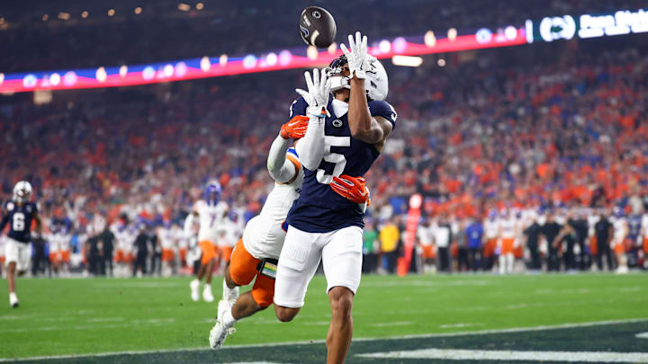 Penn State Nittany Lions wide receiver Omari Evans (5) makes a touchdown catch over Boise State Broncos safety Ty Benefield (0) during the first half in the Fiesta Bowl at State Farm Stadium.