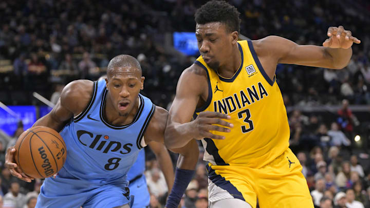 Feb 6, 2025; Inglewood, California, USA;  Los Angeles Clippers guard Kris Dunn (8) beats Indiana Pacers center Thomas Bryant (3) to a rebound in the second half at Intuit Dome. Mandatory Credit: Jayne Kamin-Oncea-Imagn Images