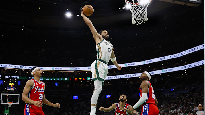 Feb 27, 2024; Boston, Massachusetts, USA; Boston Celtics forward Jayson Tatum (0) goes in for a dunk as Philadelphia 76ers forward Darius Bazley (25) and guard Ricky Council IV (16) look on during the second half at TD Garden. Mandatory Credit: Winslow Townson-Imagn Images