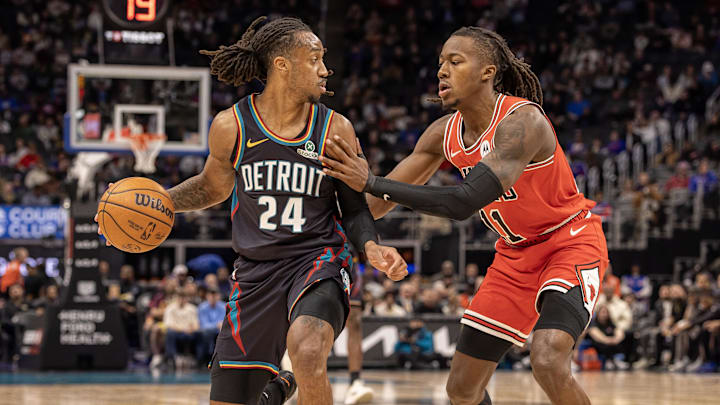 Nov 12, 2025; Detroit, Michigan, USA; Chicago Bulls guard Ayo Dosunmu (11) defends against Detroit Pistons guard Daniss Jenkins (24) during the first quarter at Little Caesars Arena. Mandatory Credit: David Reginek-Imagn Images