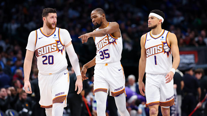 Jan 24, 2024; Dallas, Texas, USA;  Phoenix Suns forward Kevin Durant (35) and Phoenix Suns guard Devin Booker (1) and Phoenix Suns center Jusuf Nurkic (20) talk during the third quarter against the Dallas Mavericks at American Airlines Center. Mandatory Credit: Kevin Jairaj-Imagn Images