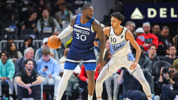 Minnesota Timberwolves forward Julius Randle (30) is defended by Atlanta Hawks forward Zaccharie Risacher in the first quarter at State Farm Arena in Atlanta on Dec. 23, 2024.