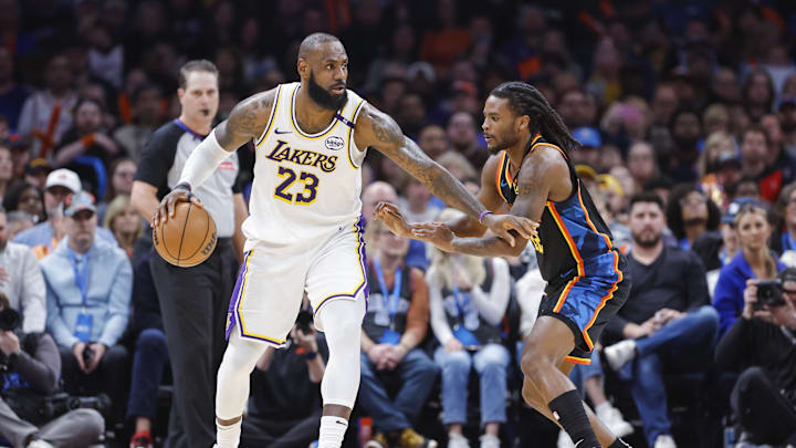 Apr 6, 2025; Oklahoma City, Oklahoma, USA; Los Angeles Lakers forward LeBron James (23) drives against Oklahoma City Thunder guard Cason Wallace (22) during the second half at Paycom Center. Mandatory Credit: Alonzo Adams-Imagn Images Apr 6, 2025; Oklahoma City, Oklahoma, USA; Los Angeles Lakers forward LeBron James (23) drives against Oklahoma City Thunder guard Cason Wallace (22) during the second half at Paycom Center. Mandatory Credit: Alonzo Adams-Imagn Images