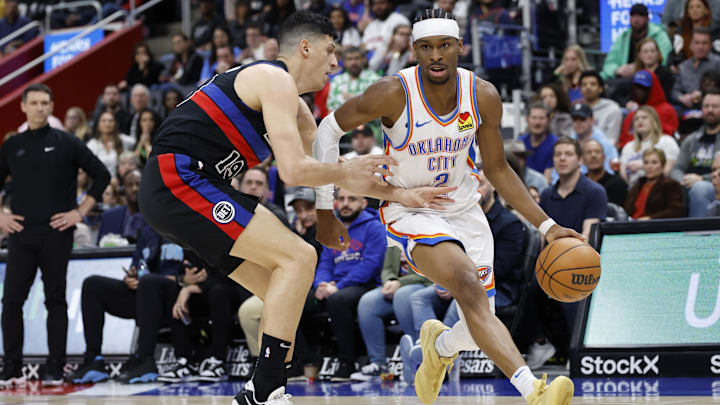Mar 15, 2025; Detroit, Michigan, USA;  Oklahoma City Thunder guard Shai Gilgeous-Alexander (2) dribbles on Detroit Pistons forward Simone Fontecchio (19) in the second half at Little Caesars Arena. Mandatory Credit: Rick Osentoski-Imagn Images