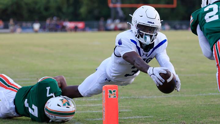 IMG Academy's Eric McFarland (3) scores a rushing touchdown against Mandarin's Tamajh Mitchell (7) during the first quarter of a high school football matchup at Mandarin High School, Friday, Sept. 19, 2025, in Jacksonville, Fla. The IMG Academy Ascenders defeated the Mandarin Mustangs 57-7. IMG Academy's Eric McFarland (3) scores a rushing touchdown against Mandarin's Tamajh Mitchell (7) during the first quarter of a high school football matchup at Mandarin High School, Friday, Sept. 19, 2025, in Jacksonville, Fla. The IMG Academy Ascenders defeated the Mandarin Mustangs 57-7.