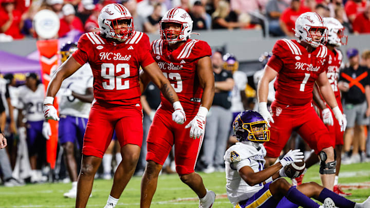 Aug 28, 2025; Raleigh, North Carolina, USA; North Carolina State Wolfpack defensive end Chase Bond (92) celebrates a sack against East Carolina Pirates quarterback Mike Wright Jr. (11) during the first half of the game at Carter-Finley Stadium. Mandatory Credit: Jaylynn Nash-Imagn Images Aug 28, 2025; Raleigh, North Carolina, USA; North Carolina State Wolfpack defensive end Chase Bond (92) celebrates a sack against East Carolina Pirates quarterback Mike Wright Jr. (11) during the first half of the game at Carter-Finley Stadium. Mandatory Credit: Jaylynn Nash-Imagn Images