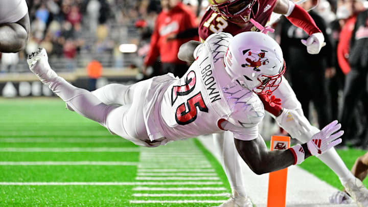 Oct 25, 2024; Chestnut Hill, Massachusetts, USA; Louisville Cardinals running back Isaac Brown (25) dives for a touchdown against the Boston College Eagles during the first half at Alumni Stadium. Mandatory Credit: Eric Canha-Imagn Images