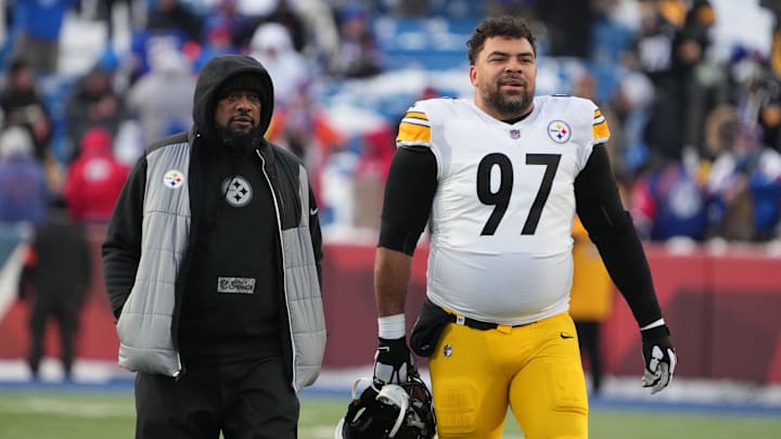 Pittsburgh Steelers head coach Mike Tomlin walks the field with  defensive tackle Cameron Heyward (97) 