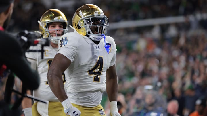 Jan 9, 2025; Miami, FL, USA; Notre Dame Fighting Irish running back Jeremiyah Love (4) celebrates a touch down in the second half against the Penn State Nittany Lions in the Orange Bowl at Hard Rock Stadium. 