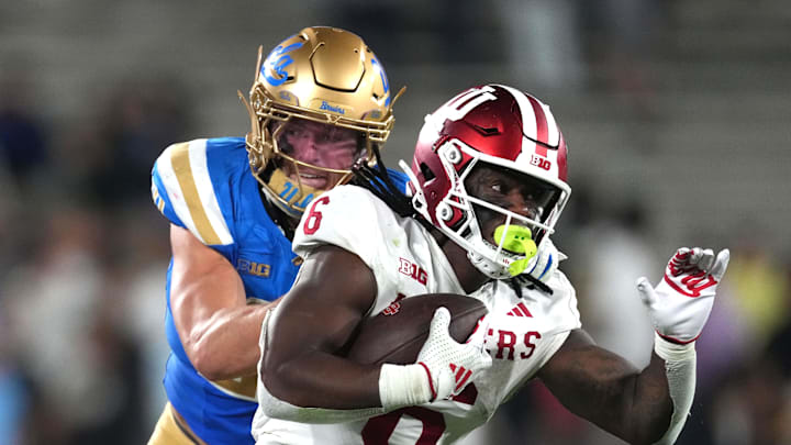 Sep 14, 2024; Pasadena, California, USA; Indiana Hoosiers running back Justice Ellison (6) carries the ball against UCLA Bruins linebacker Kain Medrano (20) in the second half at Rose Bowl. Mandatory Credit: Kirby Lee-Imagn Images