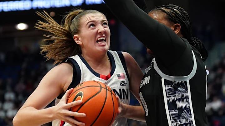 Dec 15, 2024; Storrs, Connecticut, USA; UConn Huskies guard Allie Ziebell (11) drives the ball against Georgetown Hoyas guard Jaeda Wilson (0) in the first half at XL Center. Mandatory Credit: David Butler II-Imagn Images Dec 15, 2024; Storrs, Connecticut, USA; UConn Huskies guard Allie Ziebell (11) drives the ball against Georgetown Hoyas guard Jaeda Wilson (0) in the first half at XL Center. Mandatory Credit: David Butler II-Imagn Images
