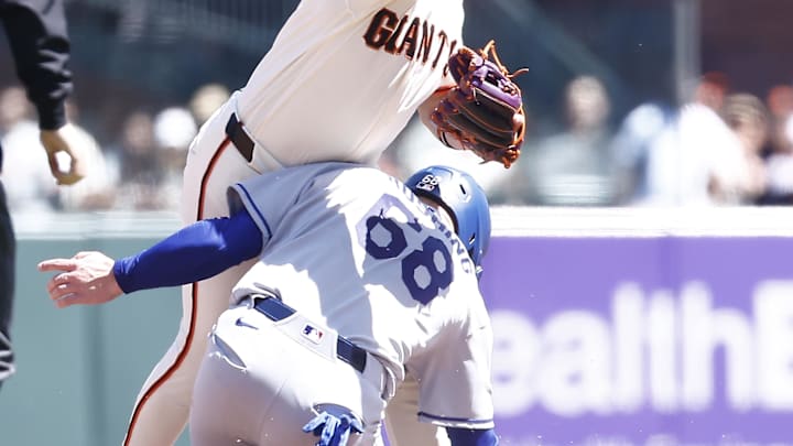 Apr 23, 2026; San Francisco, California, USA; Los Angeles Dodgers catcher Dalton Rushing (68) slides into San Francisco Giants shortstop Willy Adames (2) during the sixth inning at Oracle Park. Mandatory Credit: Kelley L Cox-Imagn Images