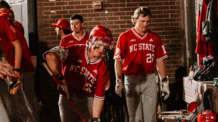 2B Luke Nixon (middle) participates in NC State's hockey celebration after hitting a home run in his team's 10-3 road win over East Carolina on Tuesday, April 15, 2026 in Greenville, N.C. 