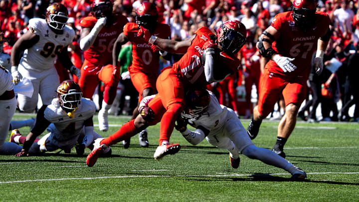 Cincinnati Bearcats defensive back Kalen Carroll (21) is tackled by Arizona State Sun Devils defensive back Xavion Alford (2) at the 1-yard-line in the second quarter of the College Football game at Nippert Stadium in Cincinnati on Saturday, Oct. 19, 2024. Cincinnati Bearcats defensive back Kalen Carroll (21) is tackled by Arizona State Sun Devils defensive back Xavion Alford (2) at the 1-yard-line in the second quarter of the College Football game at Nippert Stadium in Cincinnati on Saturday, Oct. 19, 2024.