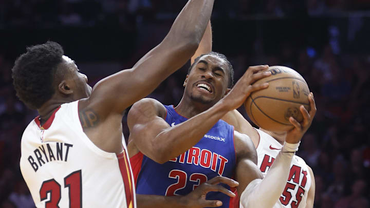 Oct 28, 2024; Miami, Florida, USA;  Miami Heat center Thomas Bryant (31) and forward Duncan Robinson (55) defend Detroit Pistons guard Jaden Ivey (23) during the second half at Kaseya Center. Mandatory Credit: Rhona Wise-Imagn Images