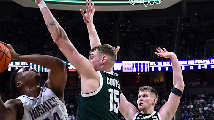 Jan 9, 2025; East Lansing, Michigan, USA; Washington Huskies center KC Ibekwe (24) looks for an opening against Michigan State Spartans center Carson Cooper (15) during the first half at Jack Breslin Student Events Center. Mandatory Credit: Dale Young-Imagn Images Jan 9, 2025; East Lansing, Michigan, USA; Washington Huskies center KC Ibekwe (24) looks for an opening against Michigan State Spartans center Carson Cooper (15) during the first half at Jack Breslin Student Events Center. Mandatory Credit: Dale Young-Imagn Images