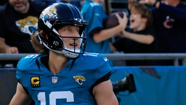Jacksonville Jaguars quarterback Trevor Lawrence (16) looks on after scoring a touchdown and giving the ball to a young fan during the first quarter of an NFL football matchup at EverBank Stadium, Sunday, Dec. 14, 2025, in Jacksonville, Fla. [Corey Perrine/Florida Times-Union]