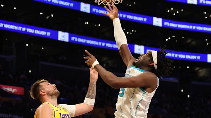 Feb 19, 2025; Los Angeles, California, USA; Charlotte Hornets center Mark Williams (5) shoots against Los Angeles Lakers guard Luka Doncic (77) during the third quarter at Crypto.com Arena. Mandatory Credit: Jason Parkhurst-Imagn Images