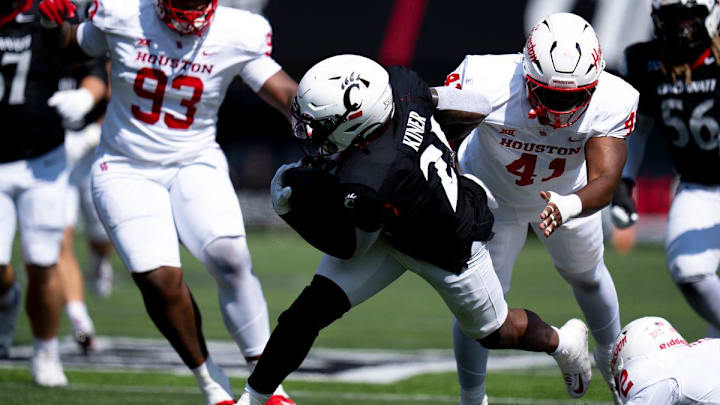 Cincinnati Bearcats defensive back Kalen Carroll (21) breaks a tackle attempt in the second quarter of the College Football game against the Houston Cougars at Nippert Stadium in Cincinnati on Saturday, Sept. 21, 2024.
