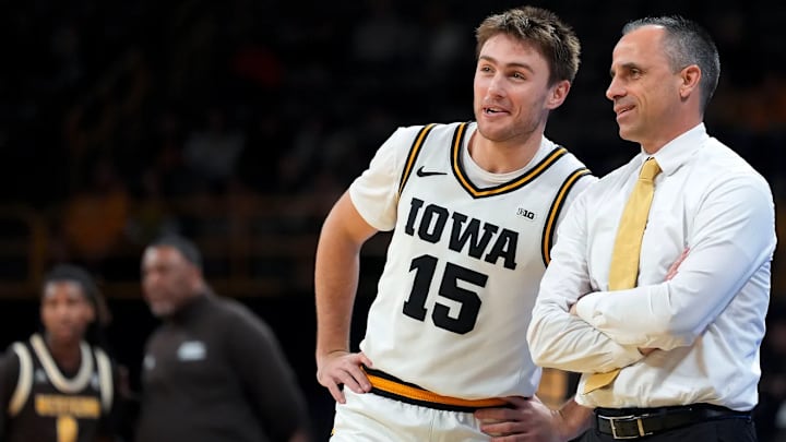 Iowa Hawkeyes guard Brendan Hausen (15) and head coach Ben McCollum Iowa Hawkeyes guard Brendan Hausen (15) and head coach Ben McCollum