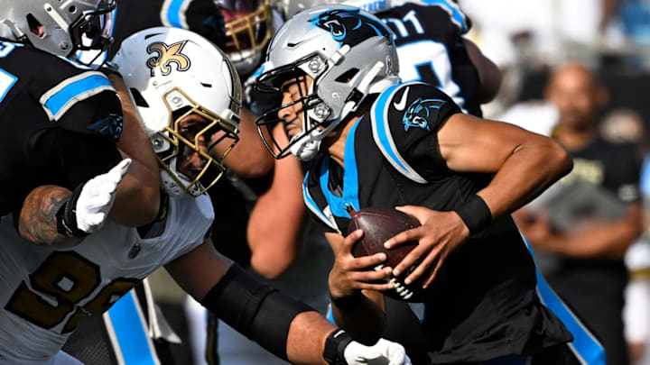 Nov 9, 2025; Charlotte, North Carolina, USA; Carolina Panthers quarterback Bryce Young (9) scrambles as New Orleans Saints defensive end Chase Young (99) pressures in the third quarter at Bank of America Stadium. Nov 9, 2025; Charlotte, North Carolina, USA; Carolina Panthers quarterback Bryce Young (9) scrambles as New Orleans Saints defensive end Chase Young (99) pressures in the third quarter at Bank of America Stadium.