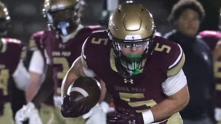 Iona Prep's Crew Davis breaks away from Chaminade's Tristan Lombardo Oct. 25, 2024. Iona Prep won 28-7.