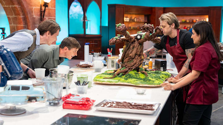 Hosts James and Oliver Phelps with Contestants Riccardo Meniccuci and Hemu Basu, as seen on Harry Potter: Wizards of Baking, Season 1.