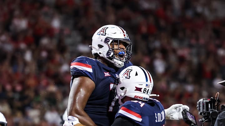 Aug 30, 2025; Tucson, Arizona, USA; Arizona Wildcats offensive lineman Michael Wooten (77) celebrates with tight end Sam Olson (84) during the third quarter of the game against the Hawaii Rainbow Warriors at Arizona Stadium. Mandatory Credit: Aryanna Frank-Imagn Images