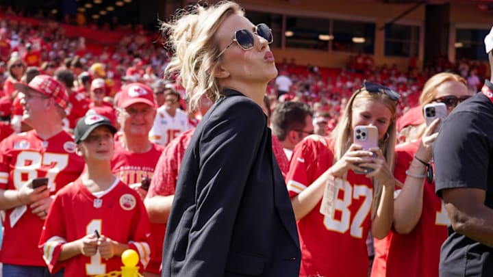 Brittany Mahomes poses on field prior to a game between the Kansas City Chiefs and Cincinnati Bengals at GEHA Field at Arrowhead Stadium.