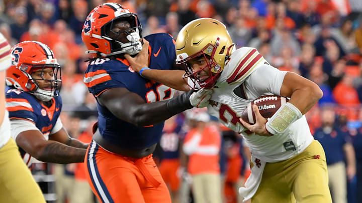 Nov 29, 2025; Syracuse, New York, USA; Boston College Eagles quarterback Grayson James (3) stiff arms Syracuse Orange linebacker David Omopariola (18) during the first half at the JMA Wireless Dome. Mandatory Credit: Rich Barnes-Imagn Images