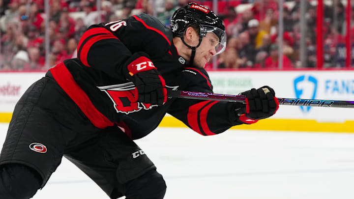 Feb 1, 2025; Raleigh, North Carolina, USA;  Carolina Hurricanes right wing Mikko Rantanen (96) takes a shot against the Los Angeles Kings during the third period at Lenovo Center. Mandatory Credit: James Guillory-Imagn Images