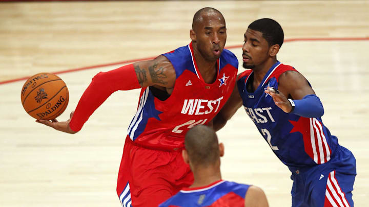 Western Conference guard Kobe Bryant (24) of the Los Angeles Lakers passes behind himself against Eastern Conference guard Kyrie Irving (2) of the Cleveland Cavaliers during the second half of the 2013 NBA All-Star Game.