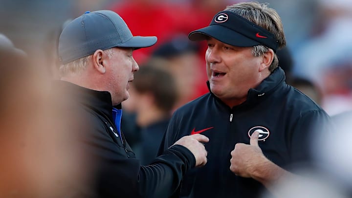 Georgia coach Kirby Smart speaks with Kentucky coach Mark Stoops before the start of a NCAA college football game against Kentucky in Athens, Ga., on Saturday, Oct. 7, 2023.