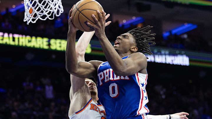 May 2, 2024; Philadelphia, Pennsylvania, USA; Philadelphia 76ers guard Tyrese Maxey (0) drives for a shot agains New York Knicks guard Donte DiVincenzo (0) during the second half of game six of the first round for the 2024 NBA playoffs at Wells Fargo Center. Mandatory Credit: Bill Streicher-Imagn Images