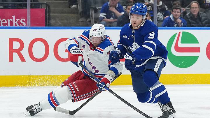 Oct 22, 2026; Toronto, Ontario, CAN;  New York Rangers centre Justin Dowling (37) battles for the puck with Toronto Maple Leafs defenseman Nick Blankenburg (3) during the second period at Scotiabank Arena.  Mandatory Credit: Nick Turchiaro-Imagn Images