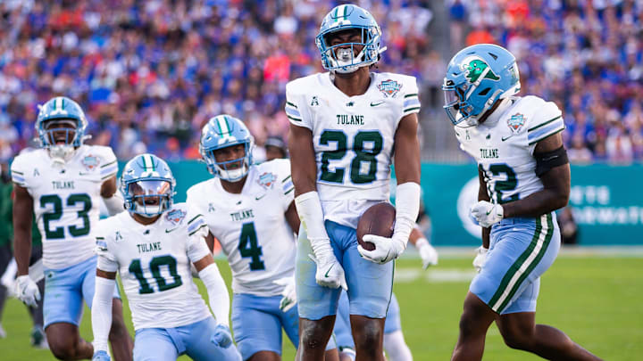 Tulane Green Wave linebacker Dickson Agu (28) celebrates after intercepting the ball during the first half at Raymond James Stadium in Tampa, FL on Friday, December 20, 2024 in the 2024 Union Home Mortgage Gasparilla Bowl.