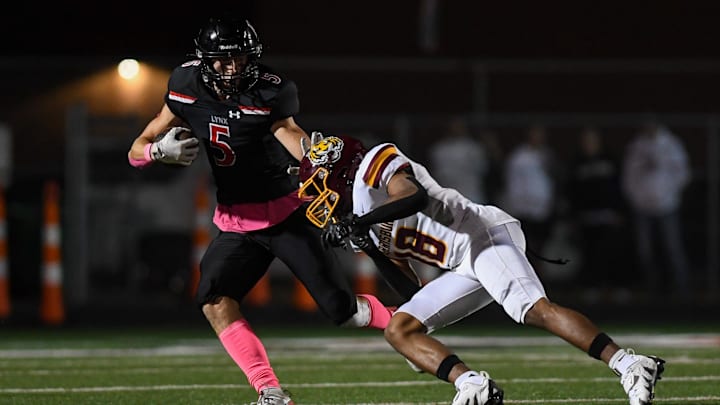 Brandon Valley wide receiver Landon Dulaney (5) evades Harrisburg quarterback Kamden Schimmel (18) on Friday, Oct. 18, 2024, at Brandon Valley High School in Brandon, South Dakota. Brandon Valley wide receiver Landon Dulaney (5) evades Harrisburg quarterback Kamden Schimmel (18) on Friday, Oct. 18, 2024, at Brandon Valley High School in Brandon, South Dakota.