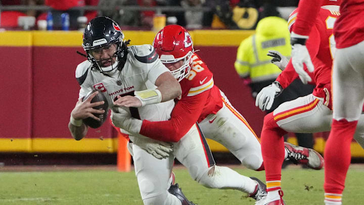 Jan 18, 2025; Kansas City, Missouri, USA; Houston Texans quarterback C.J. Stroud (7) is sacked by Kansas City Chiefs defensive end George Karlaftis (56) during the fourth quarter of a 2025 AFC divisional round game at GEHA Field at Arrowhead Stadium. Mandatory Credit: Denny Medley-Imagn Images