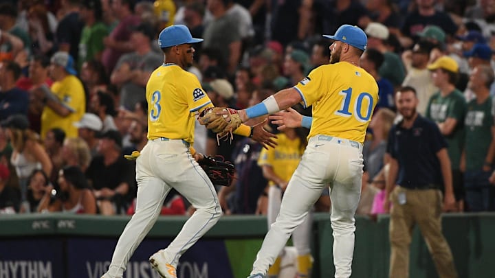 Jul 26, 2025; Boston, Massachusetts, USA;  Boston Red Sox shortstop Trevor Story (10) congratulates center fielder Ceddanne Rafaela (3) for an assist on a throw to second base ending the top of the seventh inning against the Los Angeles Dodgers at Fenway Park. Mandatory Credit: Bob DeChiara-Imagn Images