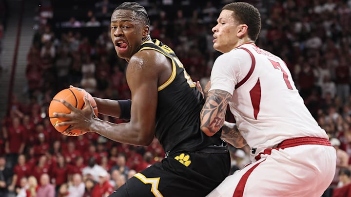 Feb 21, 2026; Fayetteville, Arkansas, USA; Missouri Tigers guard Mark Mitchell (25) drives against Arkansas Razorbacks forward Trevon Brazile (7) during the second half at Bud Walton Arena. Arkansas won 94-86.