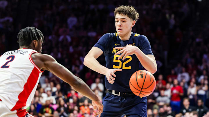 Jan 24, 2026; Tucson, Arizona, USA; Arizona Wildcats guard Dwayne Aristode (2) hits the ball out of the hands of West Virginia Mountaineers guard Treysen Eaglestaff (52) during the first half of the game at McKale Memorial Center. Mandatory Credit: Aryanna Frank-Imagn Images