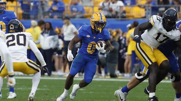 Oct 12, 2024; Pittsburgh, Pennsylvania, USA;  Pittsburgh Panthers running back Desmond Reid (0) runs the ball against the California Golden Bears during the third quarter at Acrisure Stadium. Pittsburgh won 17-15. Mandatory Credit: Charles LeClaire-Imagn Images