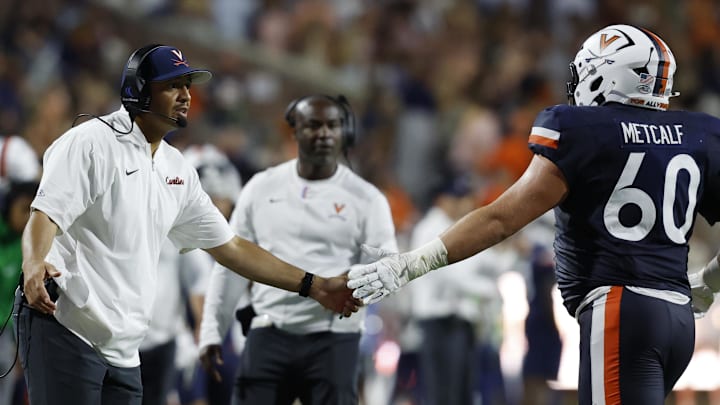 Virginia Cavaliers head coach Tony Elliott and offensive lineman Drake Metcalf Virginia Cavaliers head coach Tony Elliott and offensive lineman Drake Metcalf