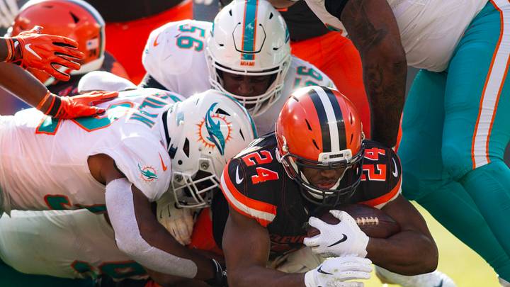 Cleveland Browns running back Nick Chubb (24) gets tackled by Miami Dolphins defensive tackles Christian Wilkins (94) and Davon Godchaux (56) along with middle linebacker Raekwon McMillan (52) during the first quarter at FirstEnergy Stadium. Cleveland Browns running back Nick Chubb (24) gets tackled by Miami Dolphins defensive tackles Christian Wilkins (94) and Davon Godchaux (56) along with middle linebacker Raekwon McMillan (52) during the first quarter at FirstEnergy Stadium.