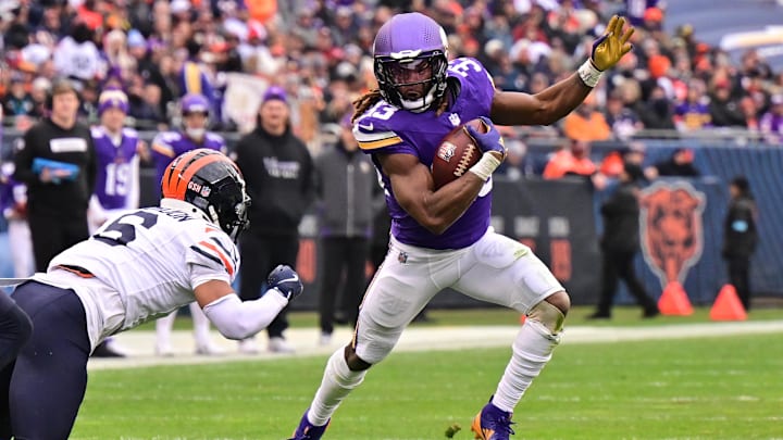 Nov 24, 2024; Chicago, Illinois, USA; Minnesota Vikings running back Aaron Jones (33) runs after a catch against the Chicago Bears during the third quarter at Soldier Field.