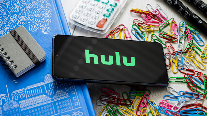 In this photo illustration a Hulu logo seen displayed on a...