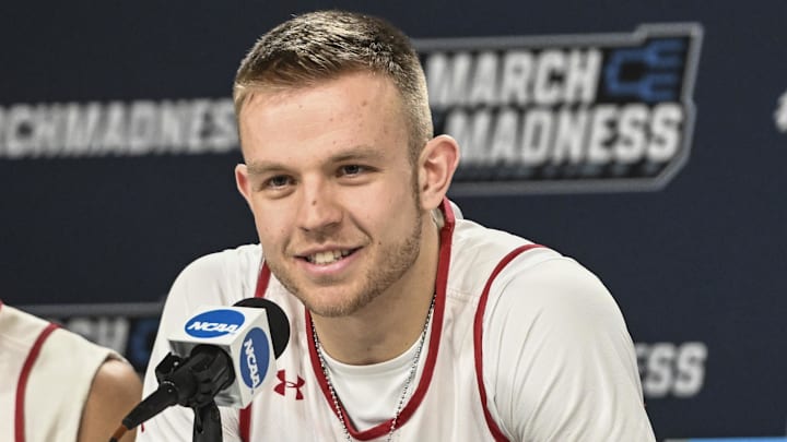 Mar 17, 2022; Milwaukee, WI, USA; Wisconsin Badgers guard Brad Davison (34) answers questions during practice before the first round of the 2022 NCAA Tournament at Fiserv Forum. Mandatory Credit: Benny Sieu-Imagn Images