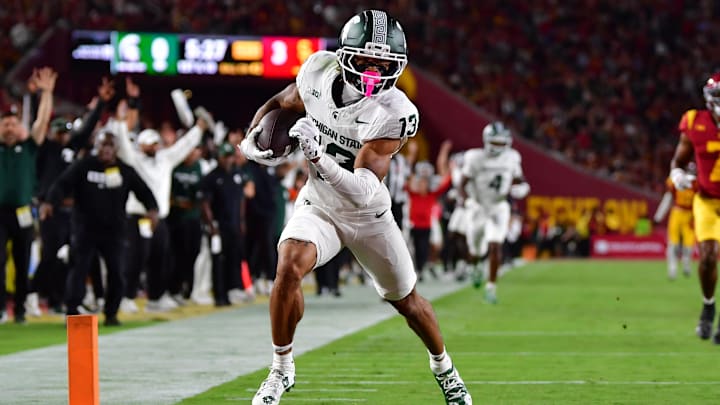 Sep 20, 2025; Los Angeles, California, USA; Michigan State Spartans wide receiver Chrishon McCray (13) scores a touchdown against the against the Southern California Trojans during the first half at the Los Angeles Memorial Coliseum. Mandatory Credit: Gary A. Vasquez-Imagn Images