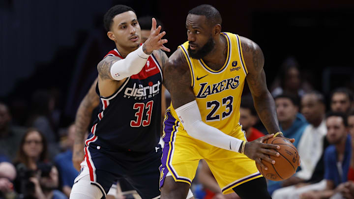 Los Angeles Lakers forward LeBron James (23) holds the ball as Washington Wizards forward Kyle Kuzma (33) defends in the second half at Capital One Arena.